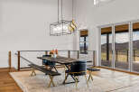 This stunning dining area features a rustic wooden table, perfect for hosting gatherings.