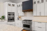 This stunning kitchen boasts modern design with sleek white cabinetry and stainless steel appliances.