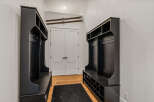 Step into this inviting entryway, featuring custom built-in storage solutions.