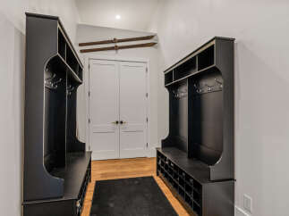 Step into this inviting entryway, featuring custom built-in storage solutions.