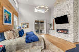 This luxurious bedroom boasts a stunning fireplace and a large flat-screen TV, perfect for cozy nights in.