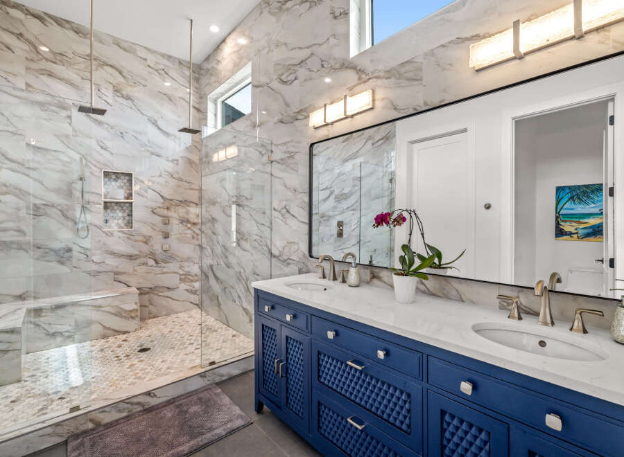 Step into luxury with this stunning bathroom featuring exquisite marble finishes and a spacious walk-in shower.