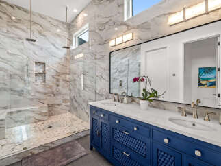Step into luxury with this stunning bathroom featuring exquisite marble finishes and a spacious walk-in shower.