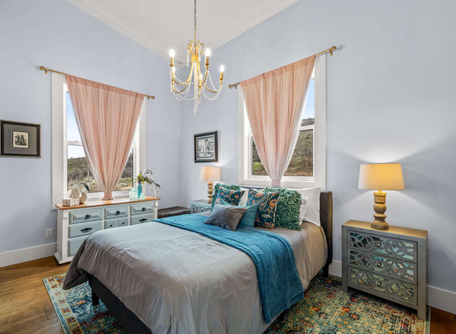 Step into this charming bedroom, featuring a serene ambiance and elegant design.