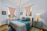 Step into this charming bedroom, featuring a serene ambiance and elegant design.