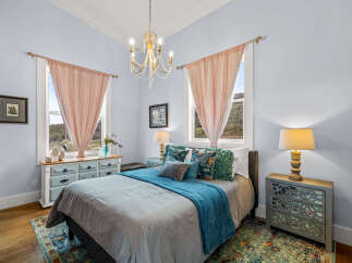 Step into this charming bedroom, featuring a serene ambiance and elegant design.