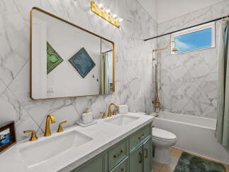 Step into luxury with this stunning bathroom! Featuring a sleek marble design, gold fixtures, and a spacious vanity, this space is perfect for relaxation.