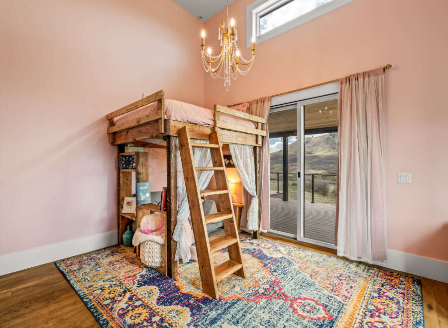 Step into this charming bedroom featuring a unique loft bed, perfect for a cozy and stylish space.
