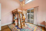 Step into this charming bedroom featuring a unique loft bed, perfect for a cozy and stylish space.