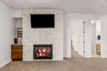 This stunning property features a cozy fireplace with a modern design, perfect for creating a warm and inviting atmosphere.