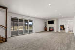 This stunning property boasts a spacious living area with a cozy fireplace and a mounted TV, perfect for relaxing evenings.