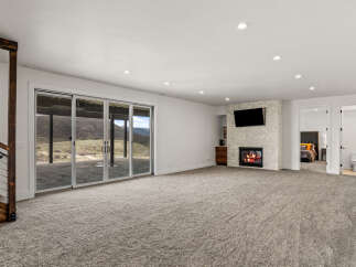This stunning property boasts a spacious living area with a cozy fireplace and a mounted TV, perfect for relaxing evenings.