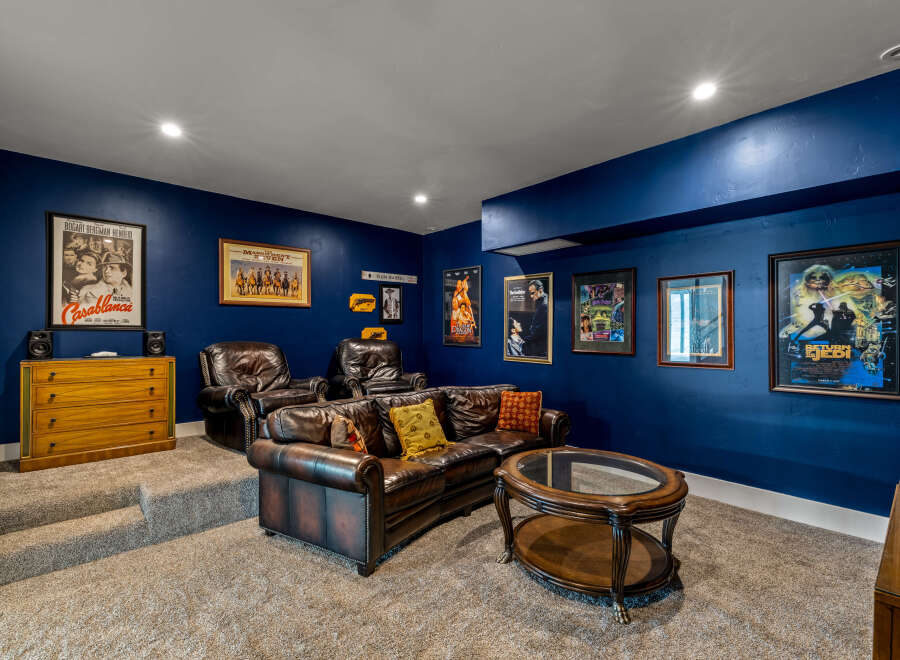 Step into your dream home theater! This stunning space boasts a luxurious leather sofa, perfect for movie nights.