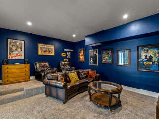 Step into your dream home theater! This stunning space boasts a luxurious leather sofa, perfect for movie nights.