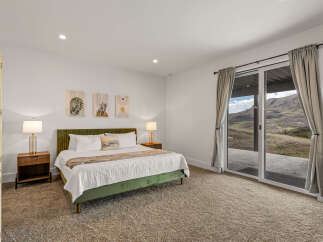 Step into luxury with this stunning bedroom featuring a plush green bed and elegant bedside lamps.