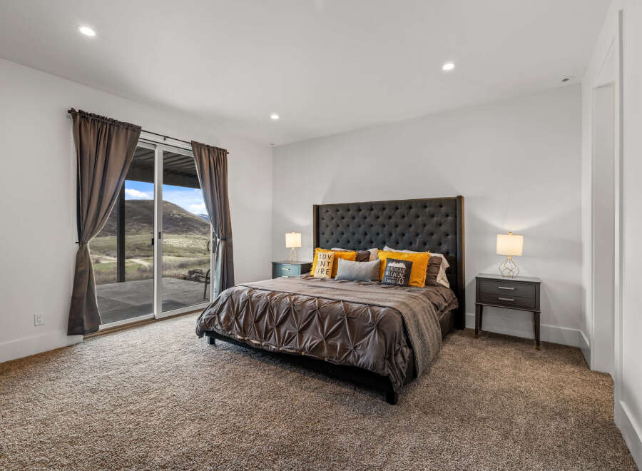 Step into luxury with this stunning bedroom, featuring a plush bed and elegant nightstands.
