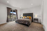 Step into luxury with this stunning bedroom, featuring a plush bed and elegant nightstands.