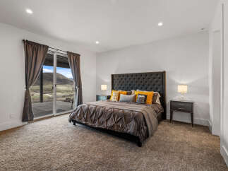 Step into luxury with this stunning bedroom, featuring a plush bed and elegant nightstands.