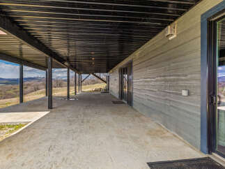 This stunning property boasts a modern design with a covered patio, perfect for enjoying the scenic mountain views.