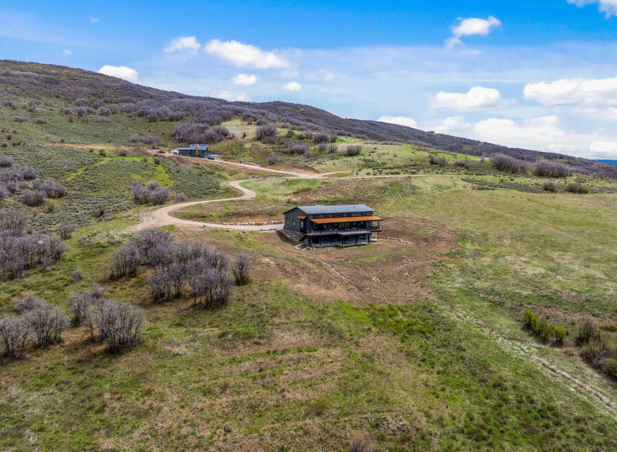 Discover your dream retreat in this stunning mountain home! This property boasts a modern design with expansive decks, perfect for enjoying breathtaking views.