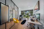 This modern office space boasts a bright and airy atmosphere, perfect for productivity.