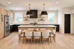 Step into this stunning modern kitchen, featuring sleek black cabinetry and a spacious island perfect for entertaining.