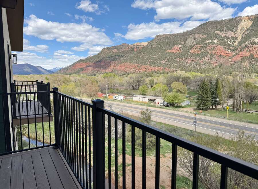 Enjoy breathtaking mountain views from this stunning property! This home features a private balcony with a sleek black railing, perfect for relaxing and taking in the scenery.