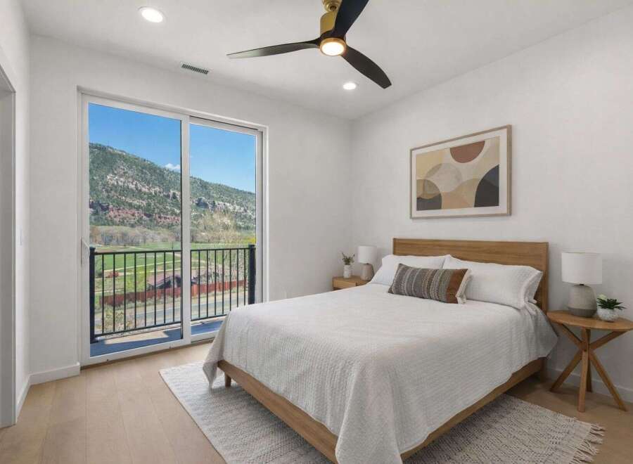This stunning bedroom offers breathtaking views of the surrounding mountains and lush greenery.