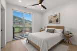 This stunning bedroom offers breathtaking views of the surrounding mountains and lush greenery.