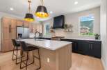 This stunning kitchen boasts a modern design with sleek cabinetry and a spacious island, perfect for both cooking and entertaining.