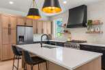 This stunning kitchen boasts a modern design with sleek cabinetry and a spacious island, perfect for culinary enthusiasts.