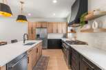 This stunning kitchen boasts a modern design with sleek cabinetry and high-end appliances.