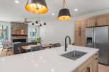 This stunning kitchen boasts modern design with sleek countertops and stainless steel appliances.