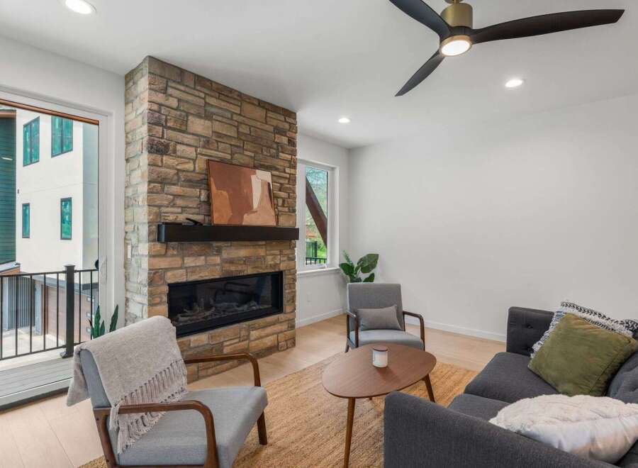 Experience luxury living in this stunning property! This home features a cozy living room with a beautiful stone fireplace, perfect for relaxing evenings.