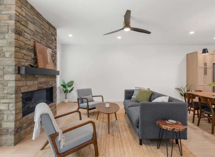 This stunning property boasts a cozy living room with a beautiful stone fireplace, perfect for those chilly evenings.