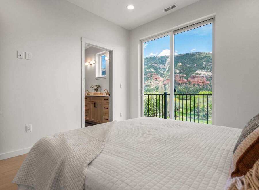 Experience breathtaking views from this stunning bedroom! This property boasts a luxurious interior with a modern design and ample natural light.
