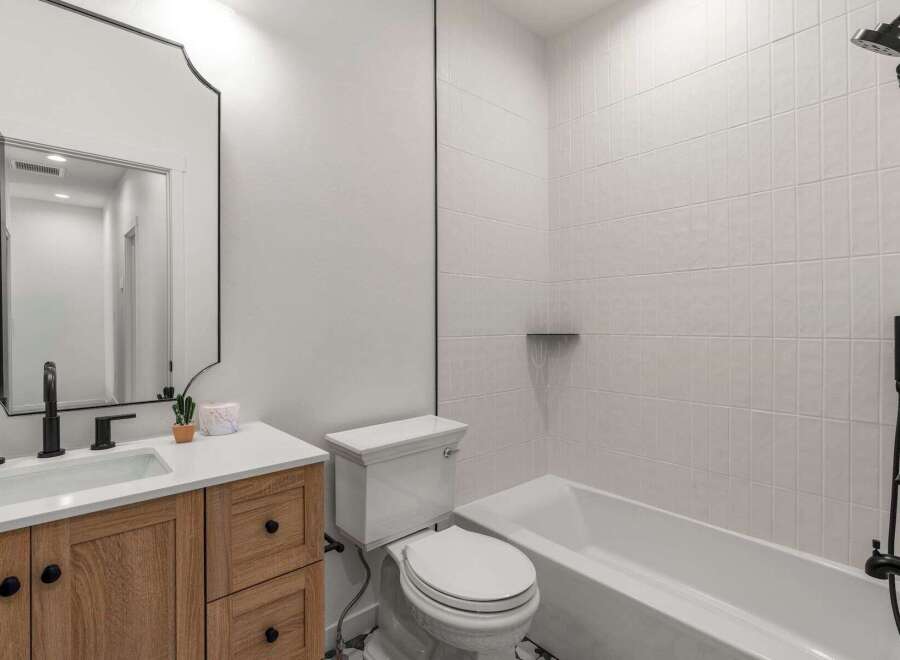 This stunning bathroom boasts a modern design with a touch of rustic charm.