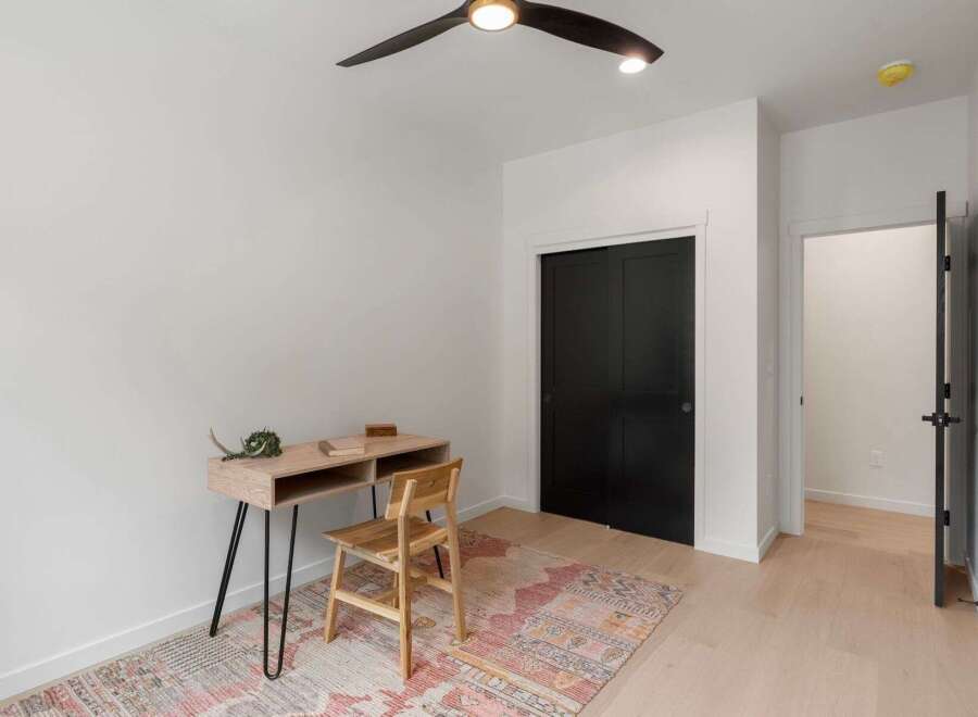 This stylish home office features a modern desk with hairpin legs and a comfortable wooden chair, perfect for productivity.