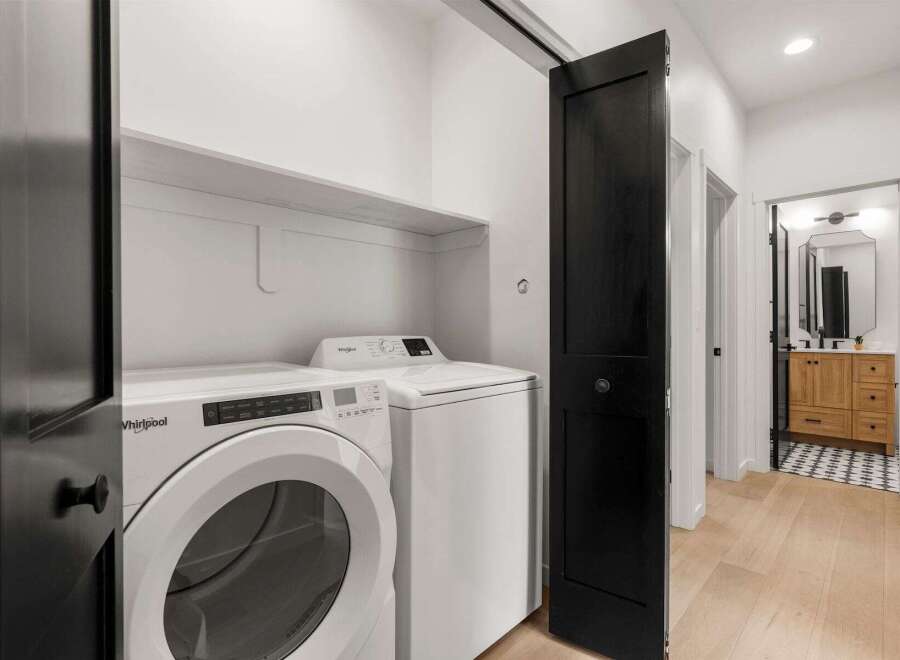Step into modern elegance with this stunning property, showcasing a beautifully designed laundry area.