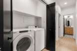 Step into modern elegance with this stunning property, showcasing a beautifully designed laundry area.