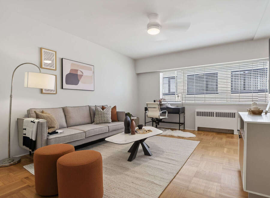 Discover modern living in this stylish apartment, featuring a spacious living area with a comfortable sofa and elegant decor.