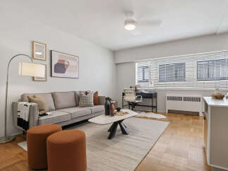 Discover modern living in this stylish apartment, featuring a spacious living area with a comfortable sofa and elegant decor.