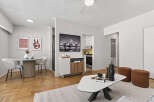 Discover modern living in this stylish apartment featuring a bright and airy living room with a unique coffee table and comfortable seating.