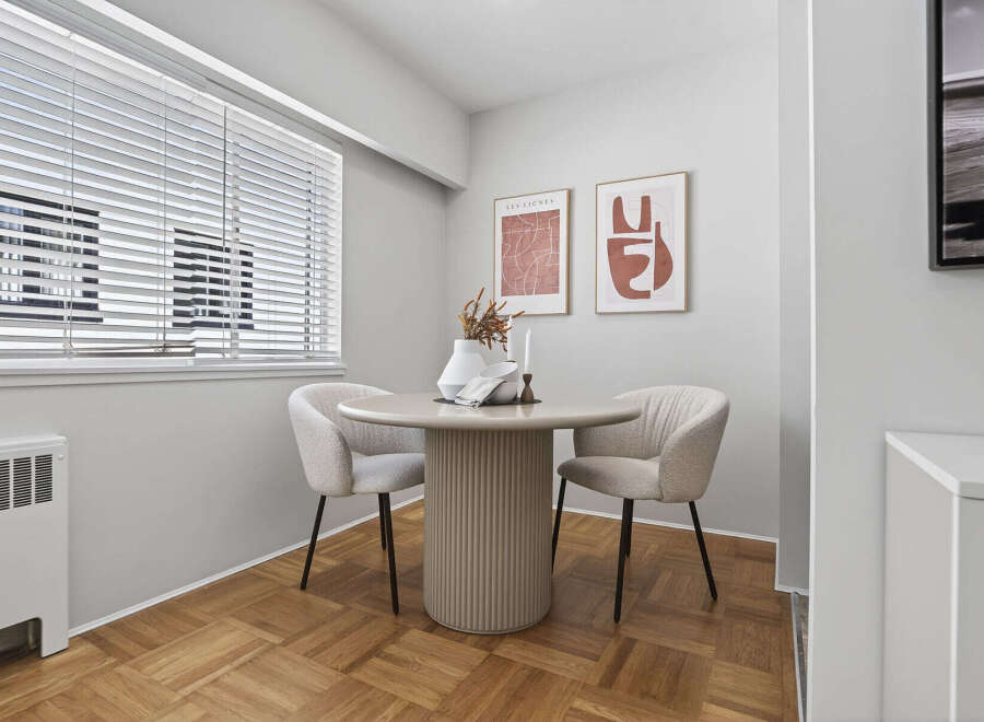 This charming dining area features a round table and two stylish chairs, perfect for intimate meals.