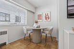 This charming dining area features a round table and two stylish chairs, perfect for intimate meals.