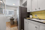 Discover this charming kitchen with a modern touch! Featuring sleek white cabinetry, a stylish sink area, and a refrigerator, this space is perfect for culinary adventures.