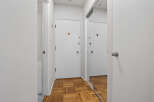 Step into this inviting entryway, featuring a stylish parquet floor and ample natural light.