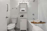 Step into this beautifully designed bathroom, featuring a modern vanity and a sleek, white color scheme.