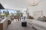 Experience luxury living in this stunning property, featuring a bright and airy living room with expansive windows.