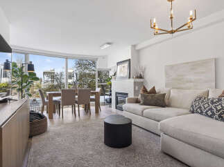 Experience luxury living in this stunning property, featuring a bright and airy living room with expansive windows.